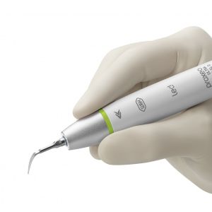 Gloved hand holding W&H Proxeo Ultra Handpiece